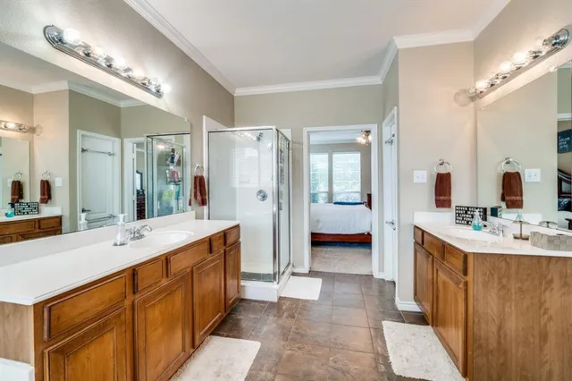 a spacious bathroom with a double vanity sink mirror double and shower