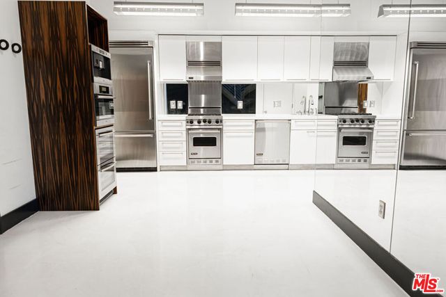 a kitchen with stainless steel appliances a refrigerator a stove and a sink