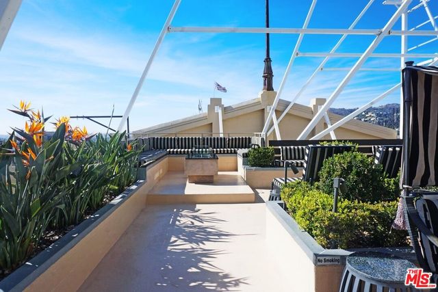 a view of a patio with table and chairs potted plants