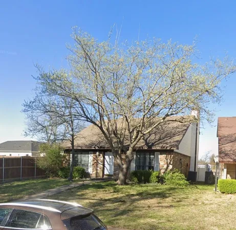 a front view of a building with a yard