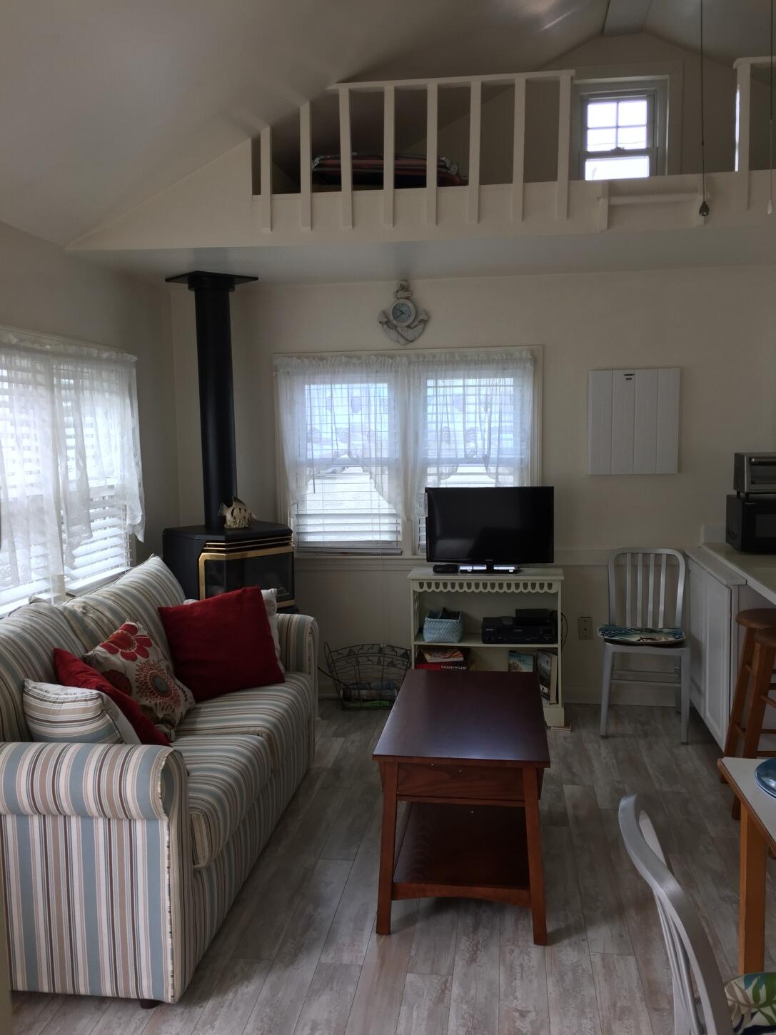 91 Glendon Road, Unit 91 Dennis Port, MA 02639 - Photo 6 of 11 a living room with furniture and windows