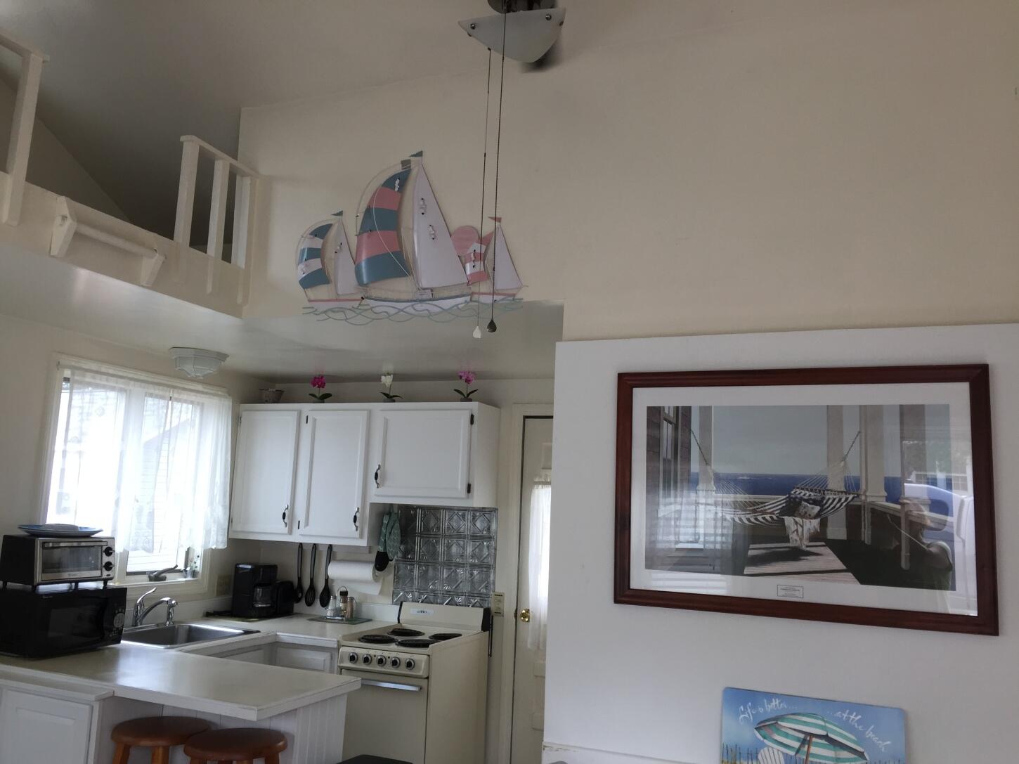 91 Glendon Road, Unit 91 Dennis Port, MA 02639 - Photo 8 of 11 a kitchen with stainless steel appliances granite countertop a sink and cabinets