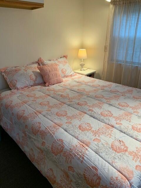 91 Glendon Road, Unit 91 Dennis Port, MA 02639 - Photo 9 of 11 a bedroom with a bed and a lamp