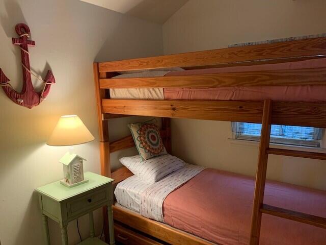 91 Glendon Road, Unit 91 Dennis Port, MA 02639 - Photo 10 of 11 a bedroom with a bed and a night stand