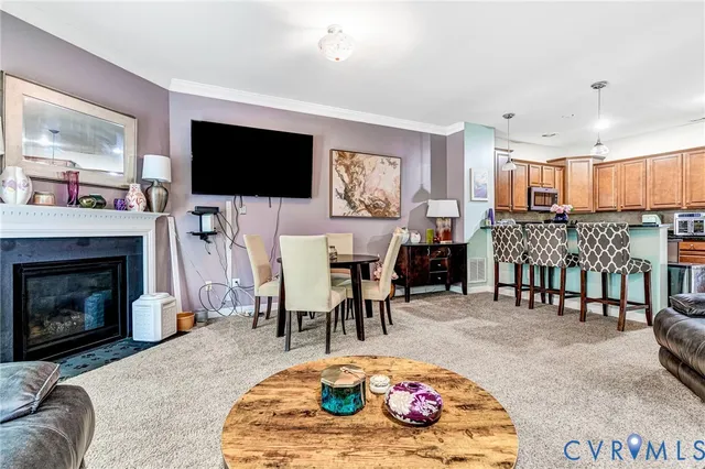 a kitchen with stainless steel appliances granite countertop a table chairs sink refrigerator and microwave