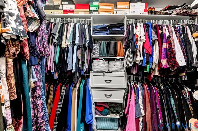 a bedroom with a bed a flat screen tv and a window