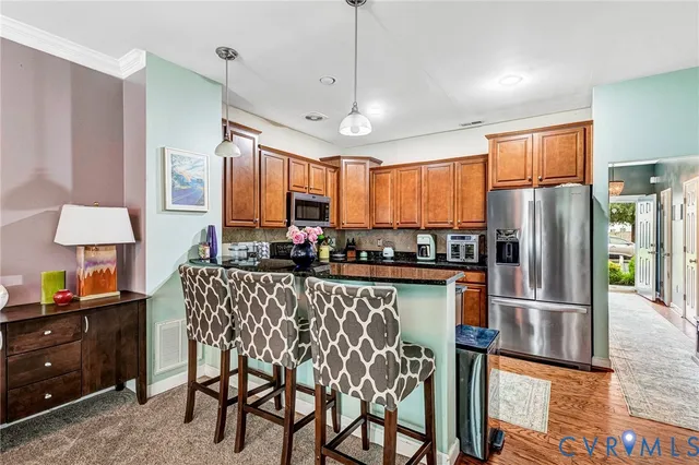 a kitchen with stainless steel appliances granite countertop a refrigerator and a sink