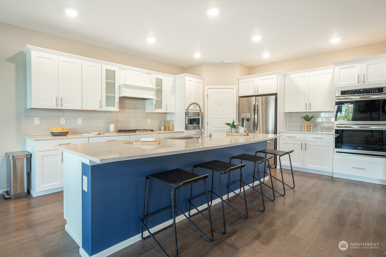 15 182nd Street Southeast Bothell, WA 98012 - Photo 5 of 32 a kitchen with stainless steel appliances granite countertop a table chairs sink refrigerator and cabinets