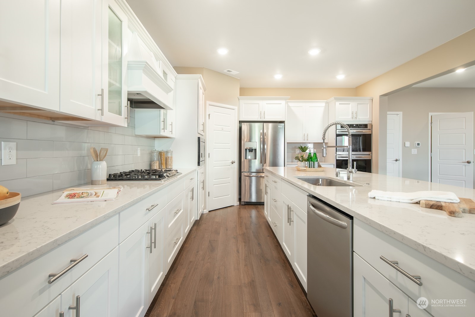 15 182nd Street Southeast Bothell, WA 98012 - Photo 6 of 32 a large kitchen with stainless steel appliances granite countertop a lot of counter space and wooden floors
