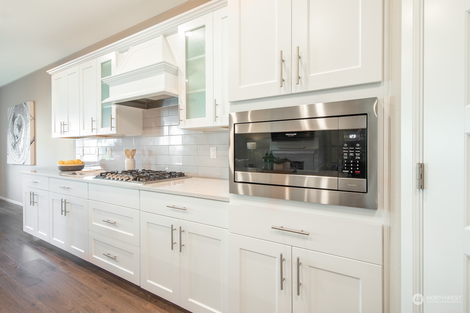 15 182nd Street Southeast Bothell, WA 98012 - Photo 8 of 32 a kitchen with granite countertop white cabinets and white appliances