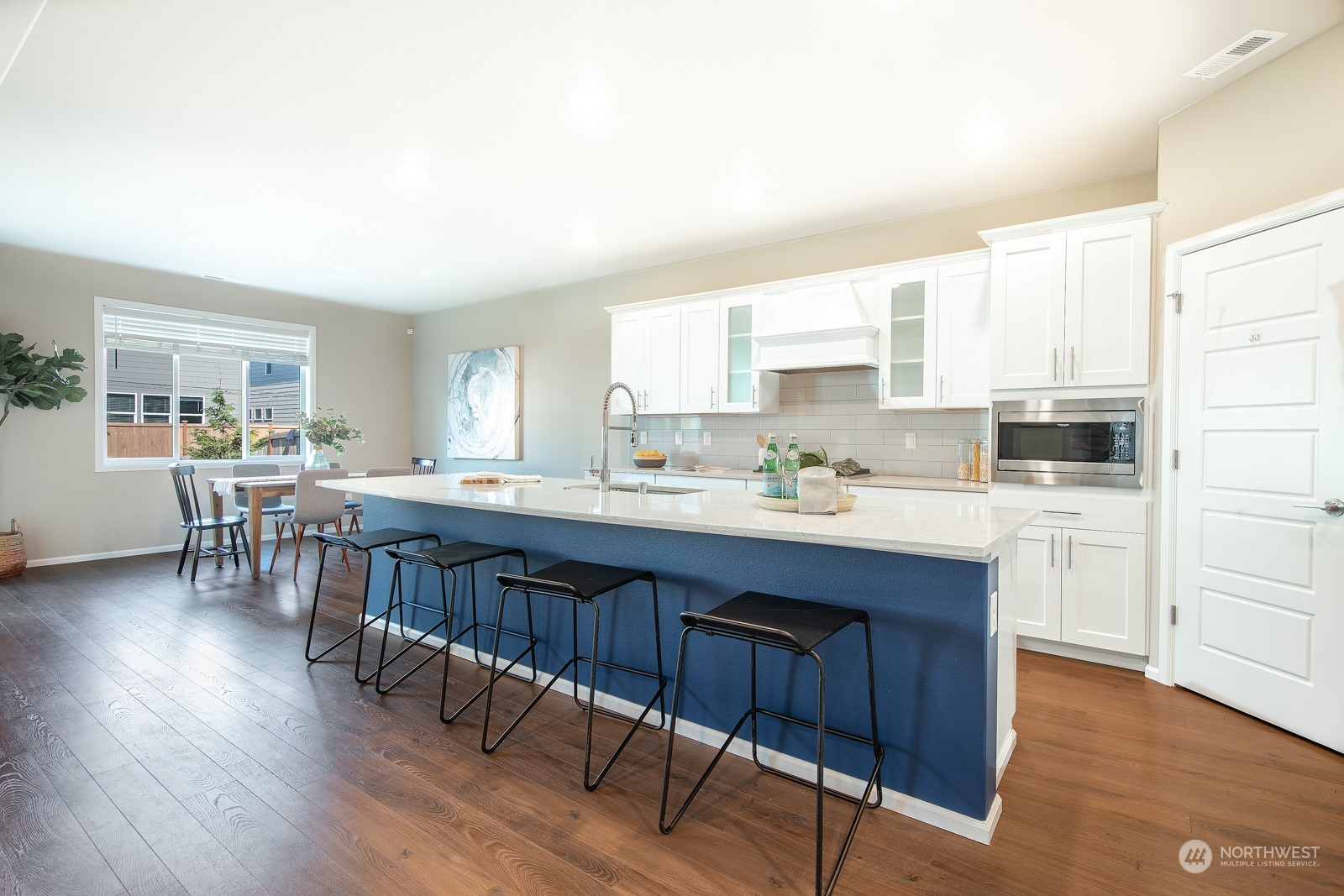 15 182nd Street Southeast Bothell, WA 98012 - Photo 10 of 32 a kitchen with stainless steel appliances granite countertop a table chairs sink and cabinets