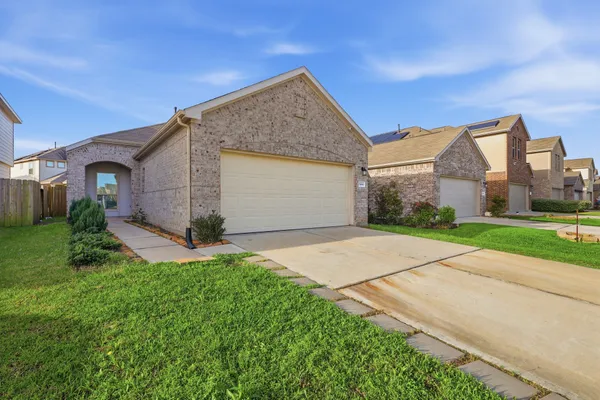 a front view of house with yard and green space