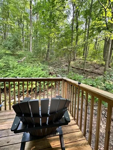 a view of a balcony with two chairs and a table