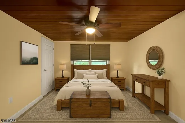 a bedroom with a bed and a lamp on dresser