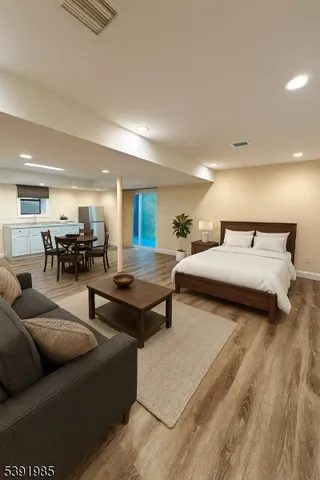 a living room with furniture and a dining table with kitchen view