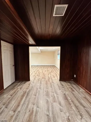 a view of hallway with wooden floor