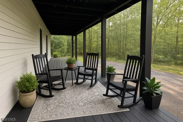 a view of two chairs and table in patio with potted plants