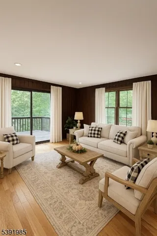 a living room with furniture and large windows