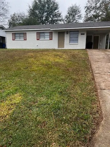a front view of house with yard and trees