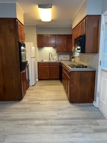 a kitchen with stainless steel appliances granite countertop a stove refrigerator and microwave