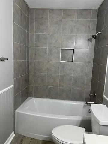 a bathroom with a toilet bathtub and shower