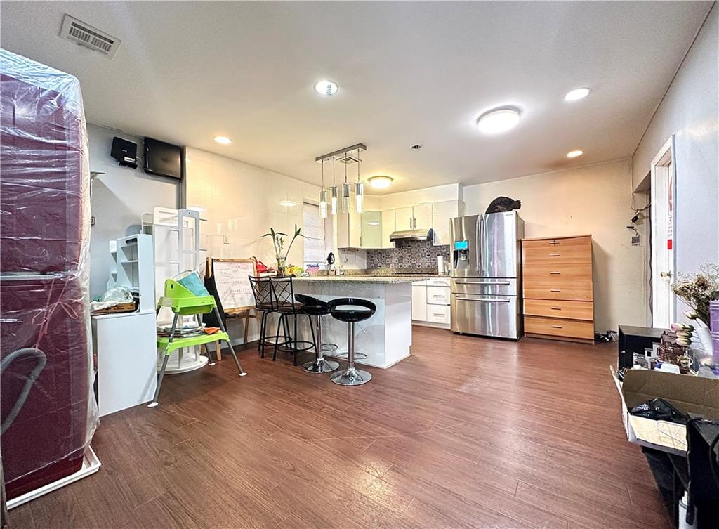 1944 85th Street Brooklyn, NY 11214 - Photo 3 of 10 a living room with lots of furniture and kitchen view