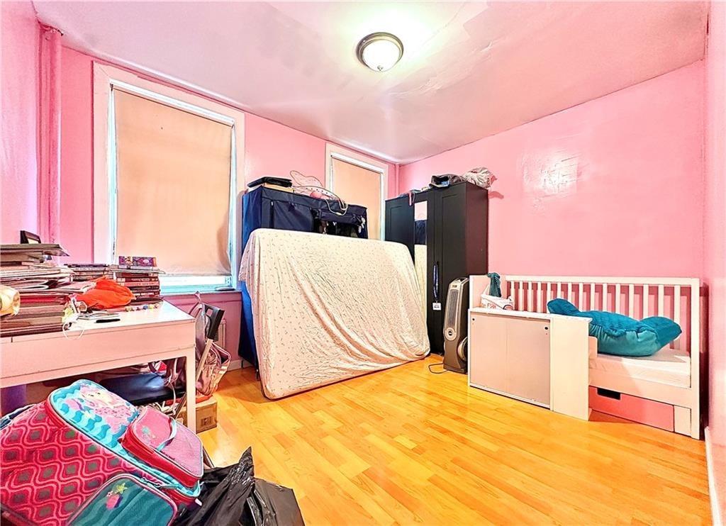 1944 85th Street Brooklyn, NY 11214 - Photo 6 of 10 a bedroom with a bed and a painting on the wall