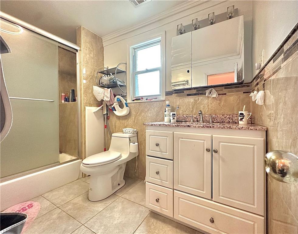 1944 85th Street Brooklyn, NY 11214 - Photo 9 of 10 a bathroom with a sink toilet and shower