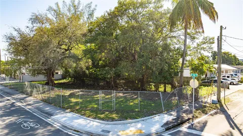 a view of a yard with large trees