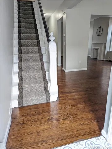 a view of entryway and hall with wooden floor