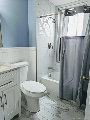 a bathroom with a toilet a sink and a bathtub