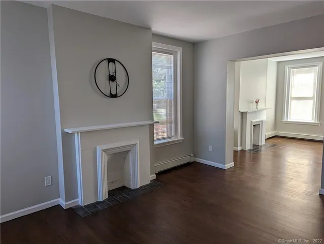 a view of a livingroom with wooden floor and a window