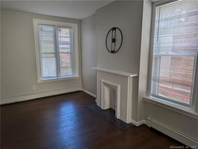 a view of a livingroom with wooden floor and a window
