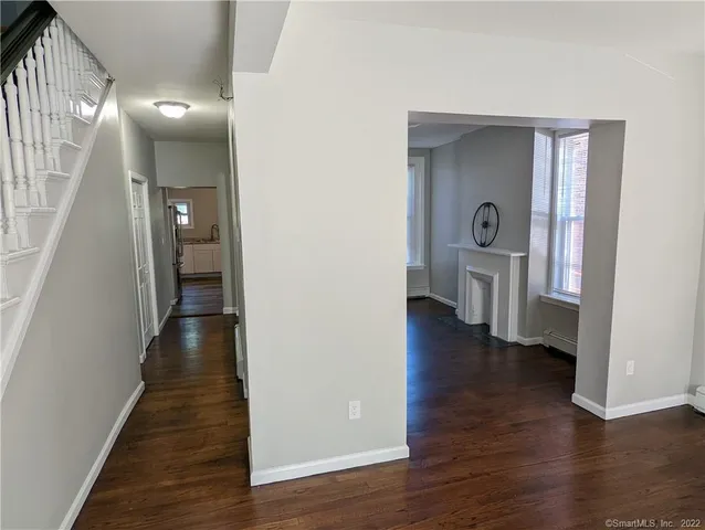 a view of a hallway with wooden floor