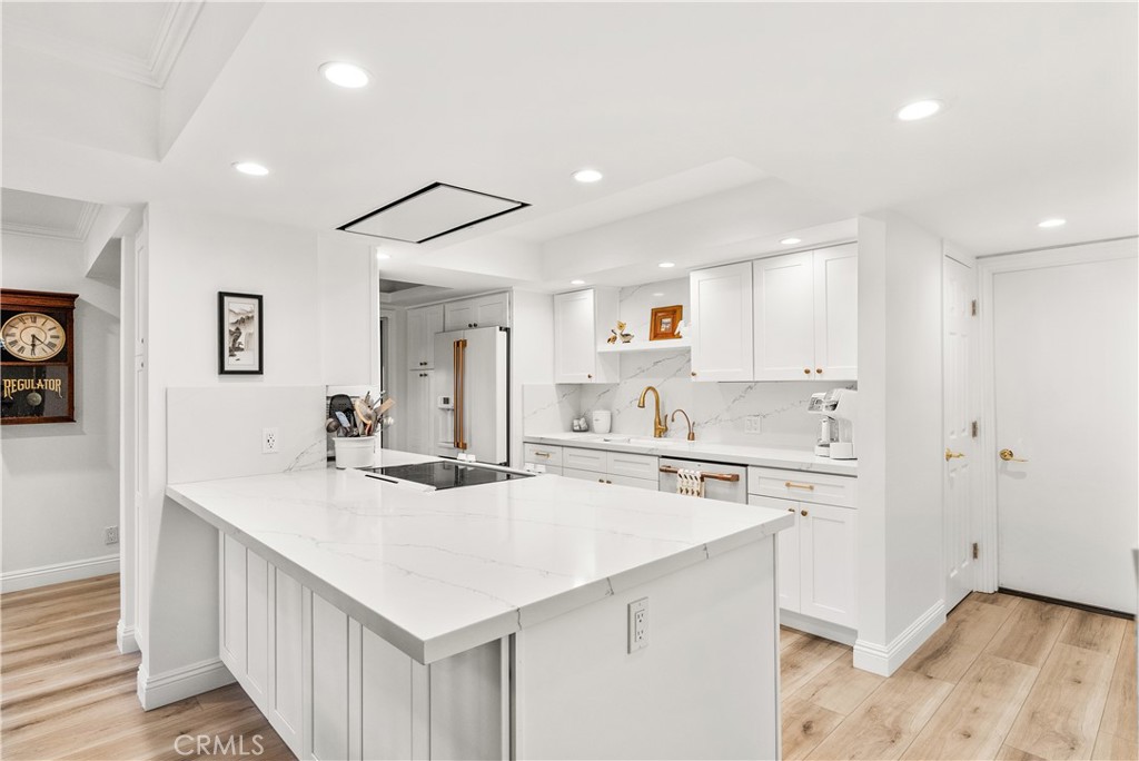 5 Canal Circle Newport Beach, CA 92663 - Photo 1 of 22 a kitchen with a sink a stove a refrigerator and white cabinets