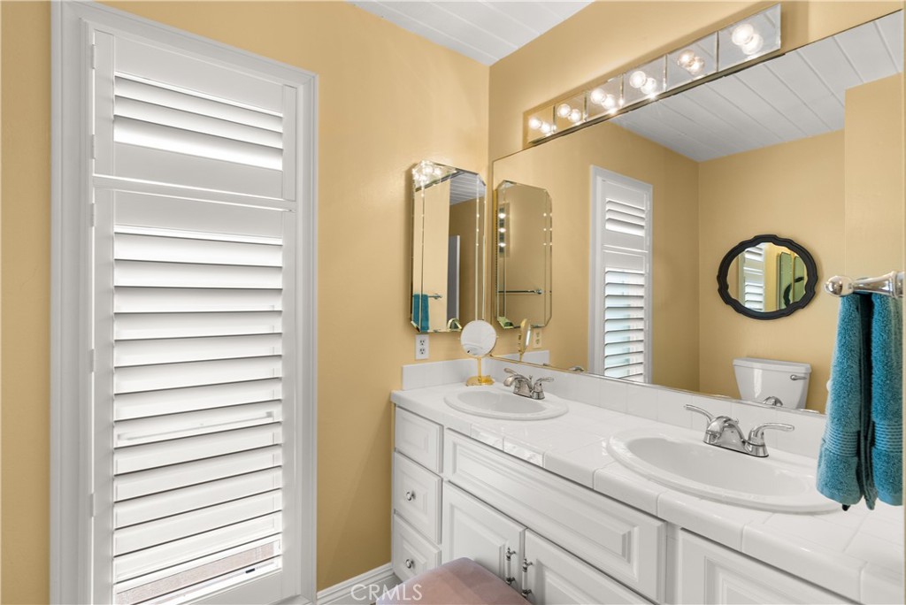 5 Canal Circle Newport Beach, CA 92663 - Photo 14 of 22 a bathroom with a sink and a mirror