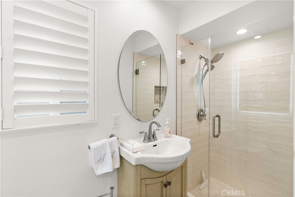 5 Canal Circle Newport Beach, CA 92663 - Photo 17 of 22 a bathroom with a sink a mirror and a shower