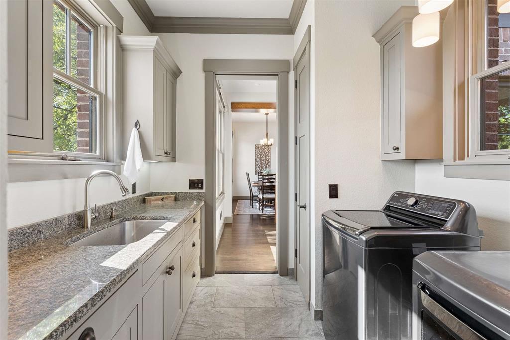 7430 Dawn Avenue Pilot Point, TX 76258 - Photo 13 of 39 a kitchen that has a sink a stove and a granite counter top next to a window
