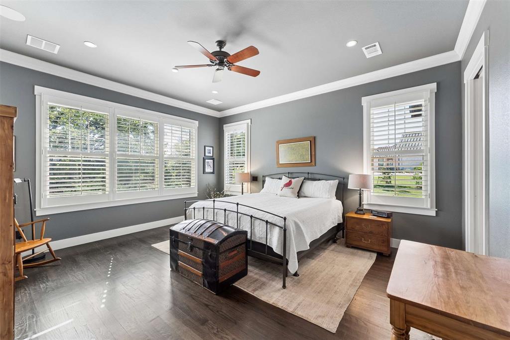 7430 Dawn Avenue Pilot Point, TX 76258 - Photo 14 of 39 a spacious bedroom with a bed and a chandelier