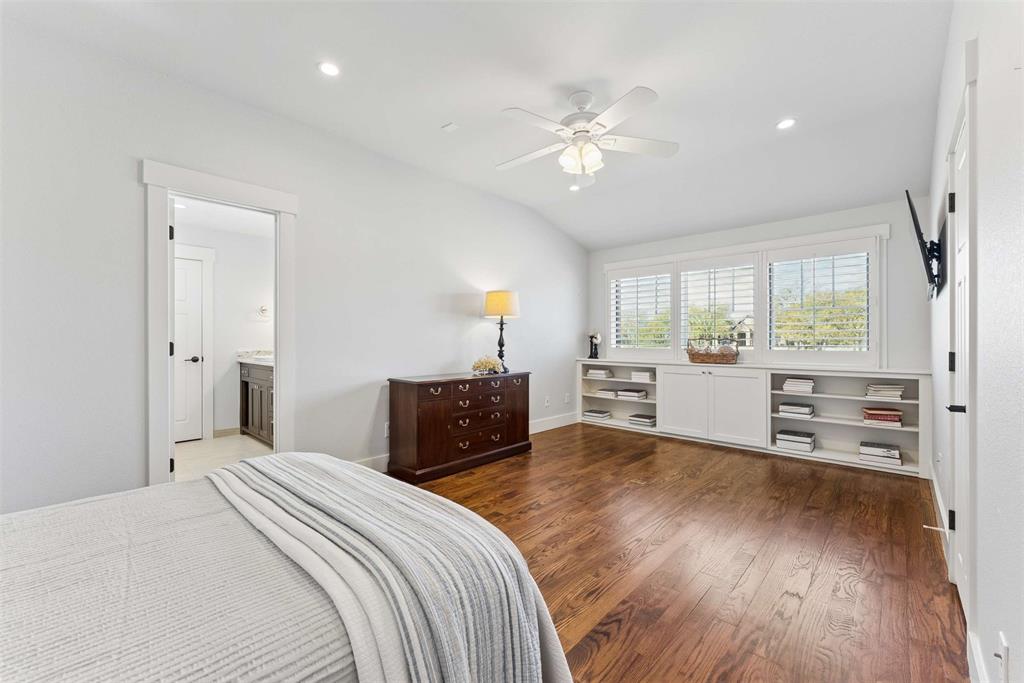 7430 Dawn Avenue Pilot Point, TX 76258 - Photo 20 of 39 a bedroom with a bed and a chandelier