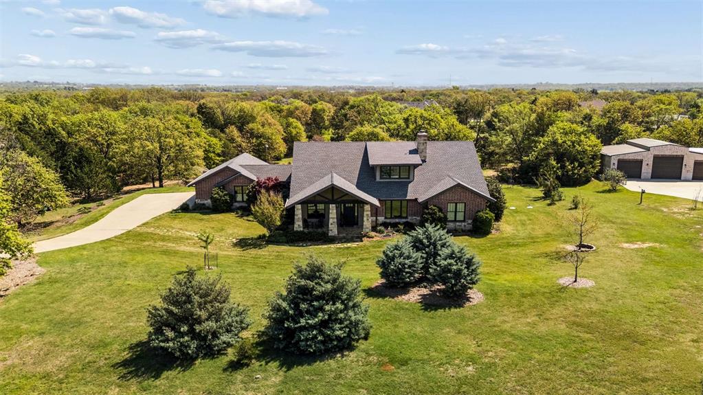 7430 Dawn Avenue Pilot Point, TX 76258 - Photo 2 of 39 a view of a lake with a house in the background
