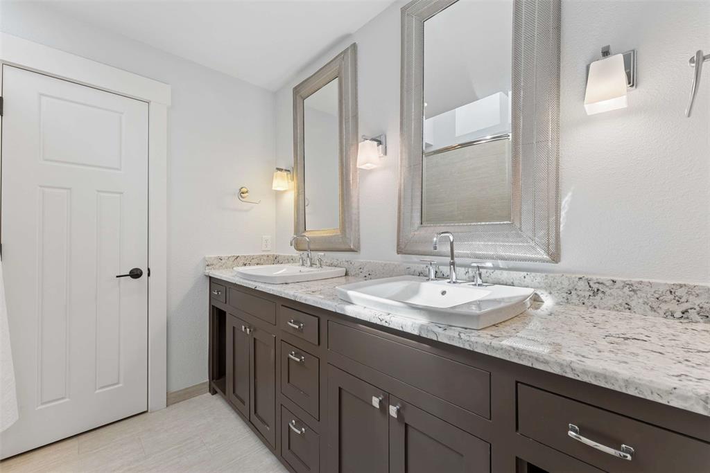 7430 Dawn Avenue Pilot Point, TX 76258 - Photo 22 of 39 a bathroom with a granite countertop sink and a mirror