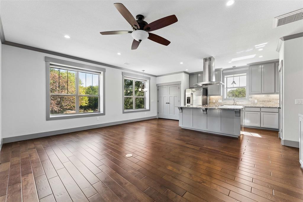 7430 Dawn Avenue Pilot Point, TX 76258 - Photo 24 of 39 a view of a kitchen with microwave and wooden floor
