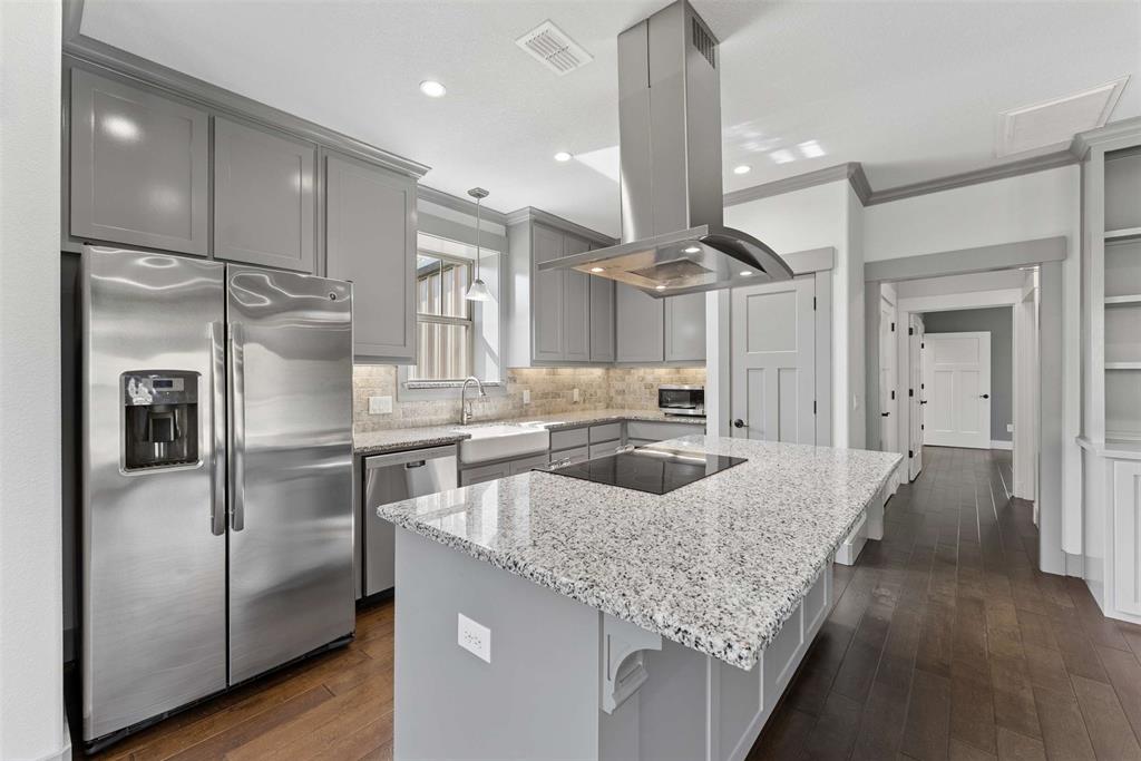 7430 Dawn Avenue Pilot Point, TX 76258 - Photo 25 of 39 a kitchen with refrigerator a sink and cabinets
