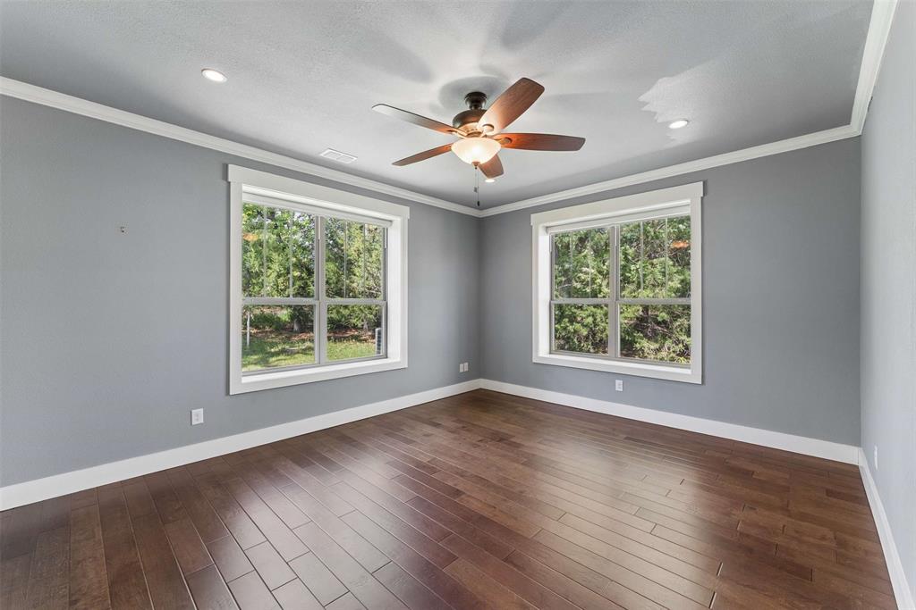 7430 Dawn Avenue Pilot Point, TX 76258 - Photo 27 of 39 a view of an empty room with wooden floor and a window