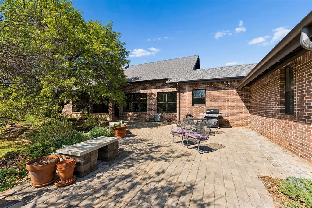 7430 Dawn Avenue Pilot Point, TX 76258 - Photo 34 of 39 a view of a patio with table and chairs and potted plants