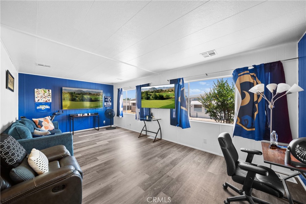 9391 California Avenue, Unit 56 Riverside, CA 92503 - Photo 1 of 45 a living room with furniture and a flat screen tv