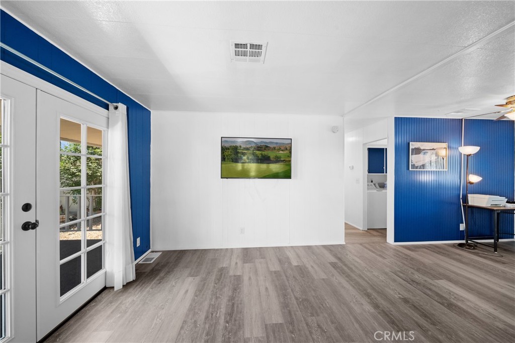 9391 California Avenue, Unit 56 Riverside, CA 92503 - Photo 16 of 45 wooden floor in an empty room with a window