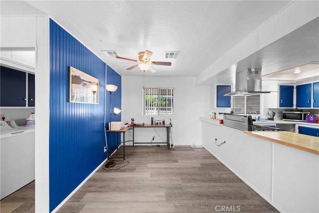 9391 California Avenue, Unit 56 Riverside, CA 92503 - Photo 22 of 45 a very nice looking living room with stainless steel appliances granite countertop furniture a rug and white walls