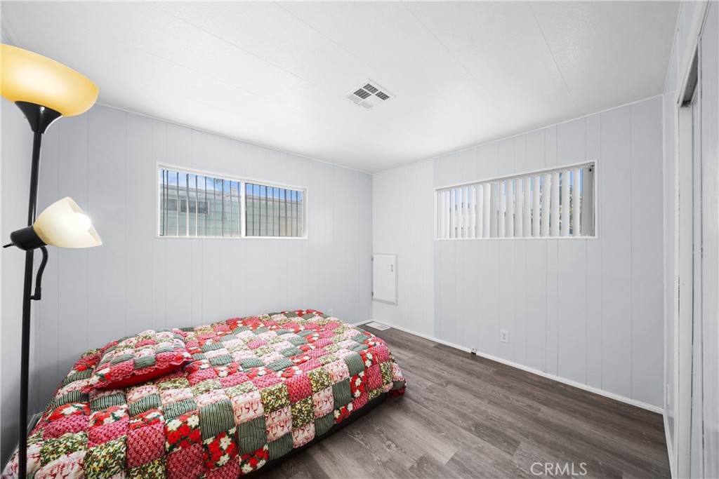 9391 California Avenue, Unit 56 Riverside, CA 92503 - Photo 25 of 45 a bedroom with a bed and a chandelier